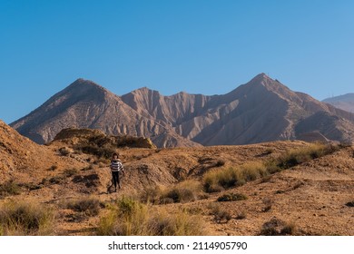 A Young Woman In The Desert Of Tabernas, Almería Province, Andalusia. On A Trek In The Rambla Del Infierno