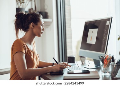 Young woman designer working on computer from her home office. - Powered by Shutterstock