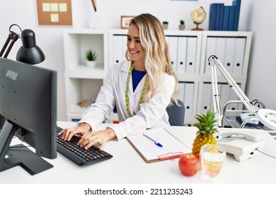 Young Woman Dietician Smiling Confident Using Computer At Clinic