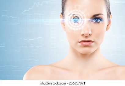 Young woman with a digital laser hologram on her eyes (ophthalmology, eye surgery and identity scanning technology concept) - Shutterstock ID 256617871