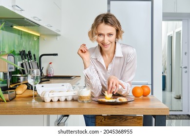 Young Woman  Dips Toast In Fried Egg