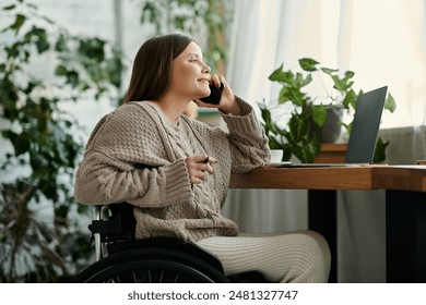 A young woman with a disability sits in her wheelchair at home, smiling as she talks on her phone. - Powered by Shutterstock