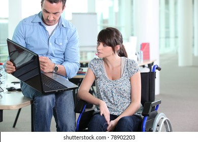 Young woman disabled with co-worker