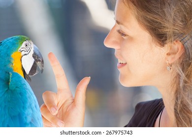 Young Woman Discussion With Parrot In Zoo