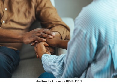 Young Woman Doctor, Adult Daughter, Carer Or Medical Nurse Holding Older Man Hands Of Senior Father, Elder Patient On Table. Retired People Health Care, Medicare And Homecare Concept. Close Up View