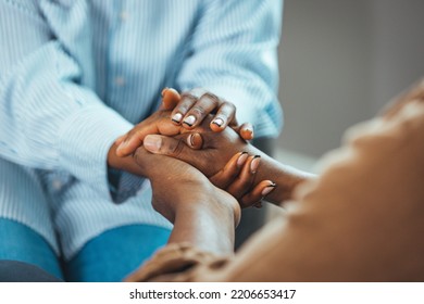 Young Woman Doctor, Adult Daughter, Carer Or Medical Nurse Holding Older Man Hands Of Senior Father, Elder Patient On Table. Retired People Health Care, Medicare And Homecare Concept. Close Up View