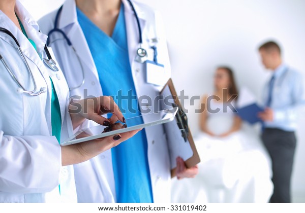 Young woman  doctor\
holding a tablet pc