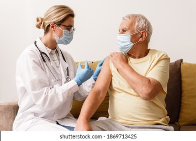 Young woman doctor injecting vaccine to elderly man during home visit - Powered by Shutterstock