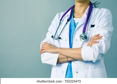 Young Woman Doctor With Medical Stetoscope Standing With Crossed Arms.