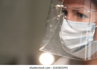 Young Woman Doctor Or Nurse Working. Girl In Medical Mask, Glasses And Shield. Red Zone, Infectious Diseases Doctor. Pandemic Coronavirus Covid19. Scientist Or Researcher. Protective Suit In Epidemic.