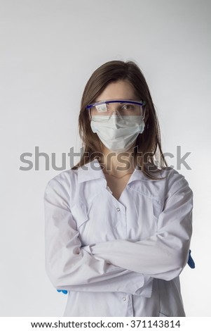 Young woman doctor on a white background gloved