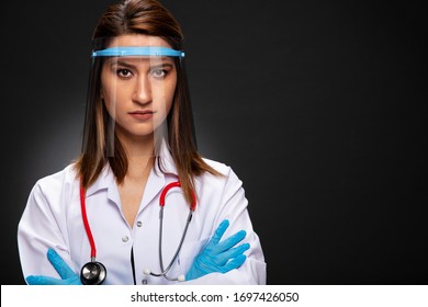 Young woman doctor posing with visor mask.