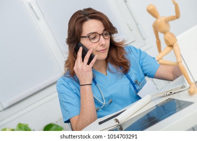 A Young Woman Doctor Talking On The Phone