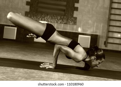 Young woman does yoga at the gym