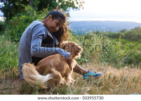 young woman with dog in the forest