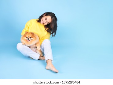 Young Woman With  Dog On  Blue Background