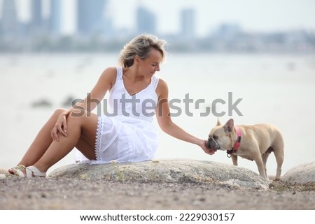 young woman with dog in summer white dress