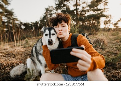 Young Woman And Dog Taking Duck Face Selfie 