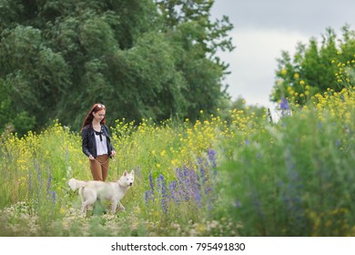 Young woman with a dog for a walk in the park 