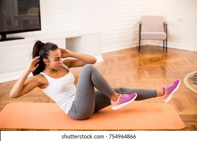 Young woman doing abs morning exercise in the room