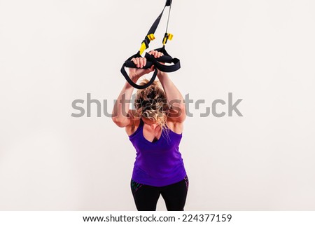 Similar – Image, Stock Photo Rear view portrait of one young middle age athletic woman at crossfit training, exercising with trx suspension fitness straps over dark background