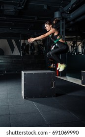 Young Woman Doing A Box Jump Exercise. Muscular Woman Doing A Box Squat At The Gym