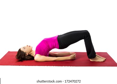 Young woman doing Bridge Pose in Yoga and Pilates (Series with the same model available)