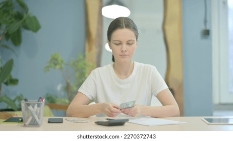 Young Woman Doing Calculations at Work - Shutterstock ID 2270372743