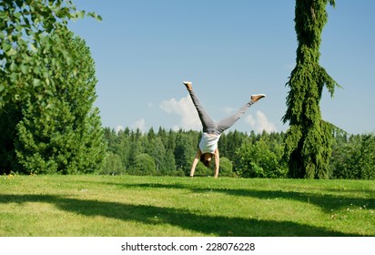 Young Woman Doing Cartwheel Outside