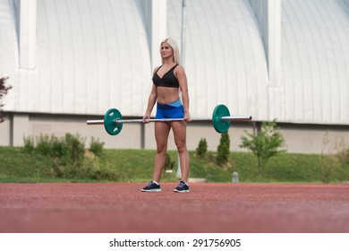Young Woman Doing A Dead Lift Exercise Outdoor
