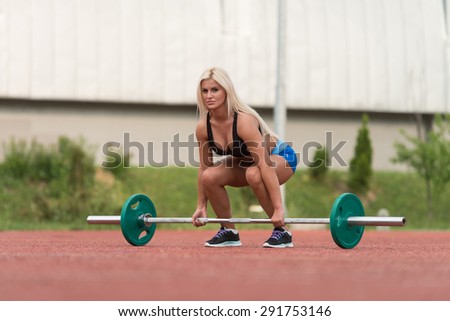 Young Woman Doing A Dead Lift Exercise Outdoor