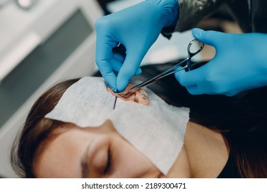 Young Woman Doing Ear Piercing At Beauty Studio Salon