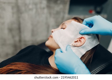 Young Woman Doing Ear Piercing At Beauty Studio Salon