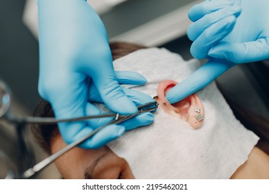 Young Woman Doing Ear Piercing At Beauty Studio Salon