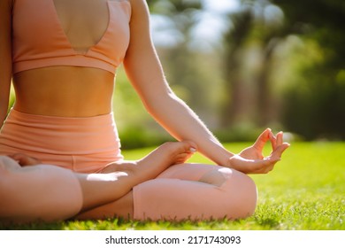 Young Woman Doing Excercise At The Public Park. Fitness Woman Doing Yoga Exercises In The Morning. Sport, Active Life.