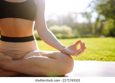 Young Woman Doing Excercise At The Public Park. Fitness Woman Doing Yoga Exercises In The Morning. Sport, Active Life.