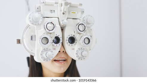 Young Woman Doing Eye Test In Clinic 