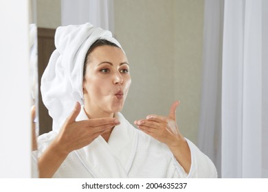 Young woman doing facial gymnastics self massage and rejuvenating exercises. Face building for skin and muscles lifting