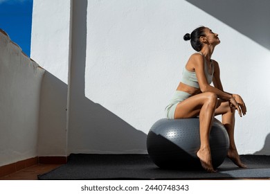 Young woman doing fitness exercises with fit ball. Fitness girl makes exercises on a fitness ball . Weightloss, bodybuilding, beauty concept - Powered by Shutterstock