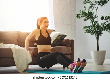 a young woman doing fitness and sports at home     - Shutterstock ID 1372315241