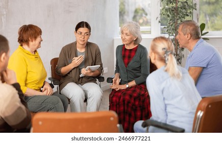 Young woman doing group training for seniors people - Powered by Shutterstock