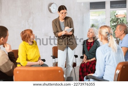 Similar – Female doctor talking to elderly patient in wheelchair