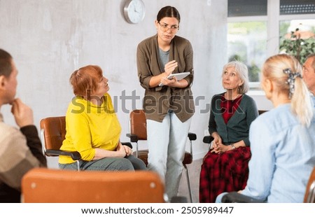 Similar – Female doctor talking to elderly patient in wheelchair