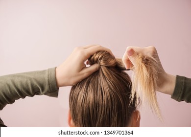 Young woman doing hair on color background - Shutterstock ID 1349701364