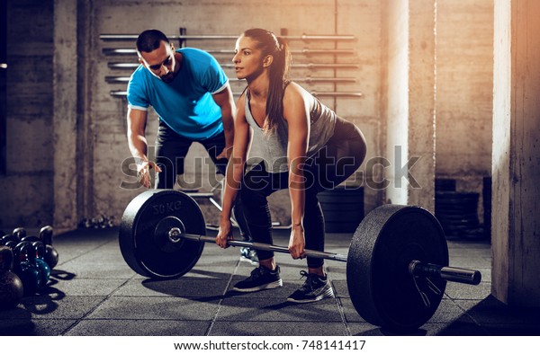 Young Woman Doing Hard Exercise Gym Stock Photo (Edit Now) 748141417