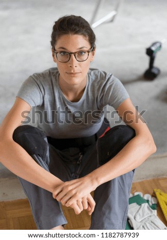 Similar – Young female sitting by table and making clay or ceramic mug in her working studio