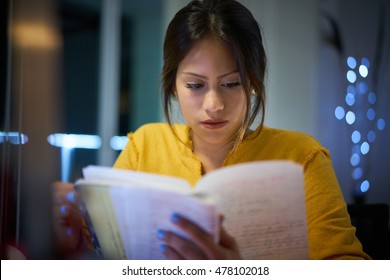 Young Woman Doing Homework At Night. Tired Hispanic Girl And College Education. Female Student Studying For Next Day Exam