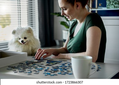 Young woman doing jigsaw puzzles