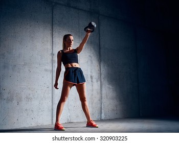 Young Woman Doing Kettlebell Swing Exercise