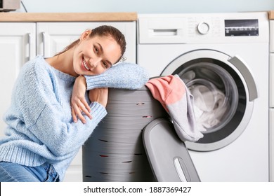 Young Woman Doing Laundry At Home